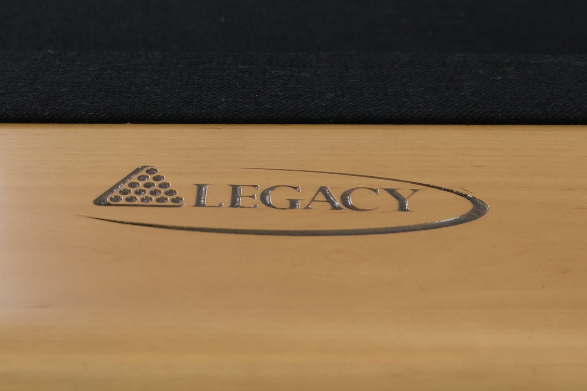 Legacy Billiards Richland Pool Table in Caramel Finish with Black Cloth - Logo Rail Closeup