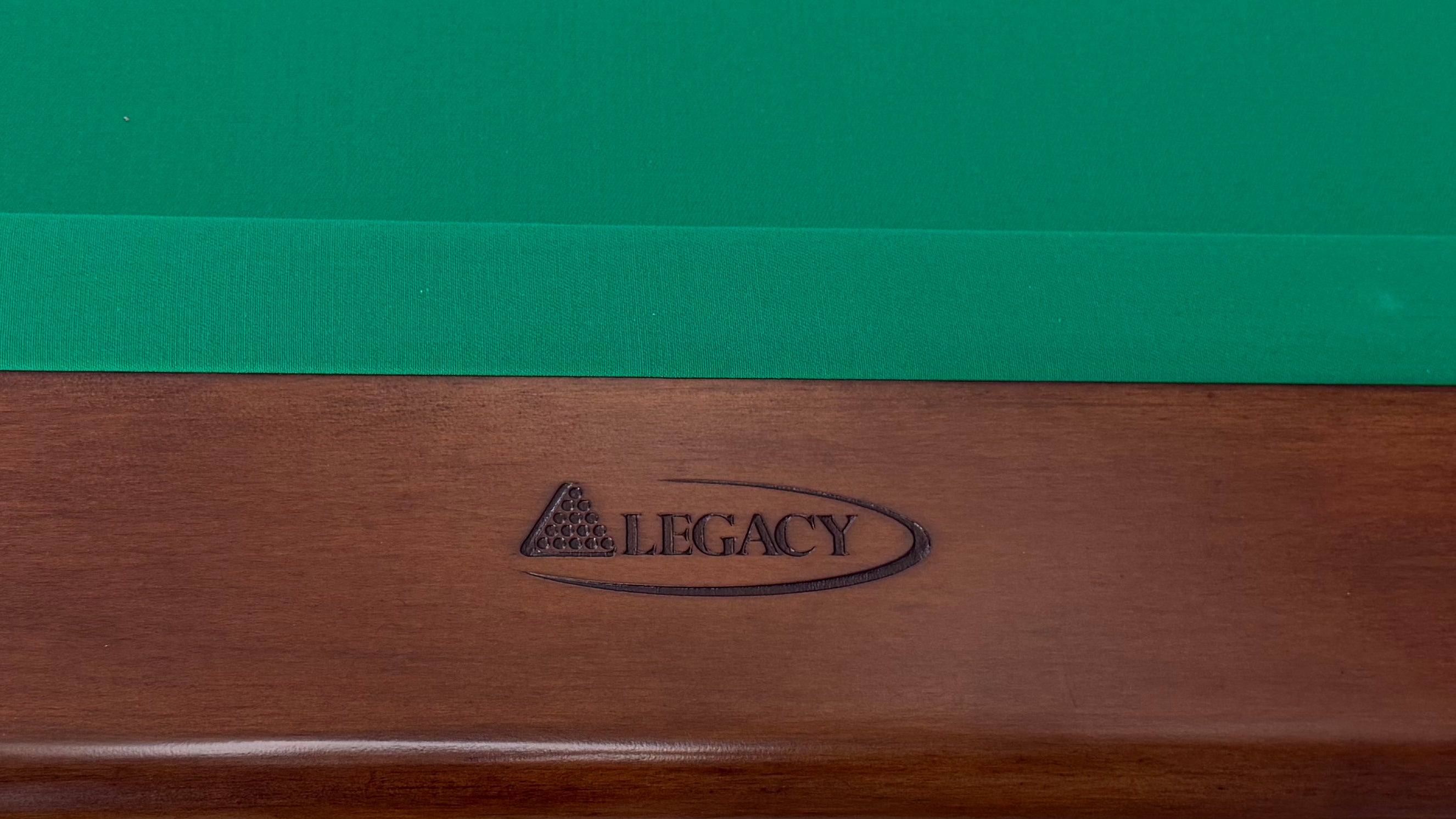 Legacy Billiards Caney Pool Table in Nutmeg Finish with Green Cloth - Rail Logo Closeup
