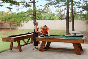 Legacy Billiards 7 Ft Barren Outdoor Pool Table in Natural Acacia Finish with People Playing Pool Outside and Emory Outdoor Shuffleboard